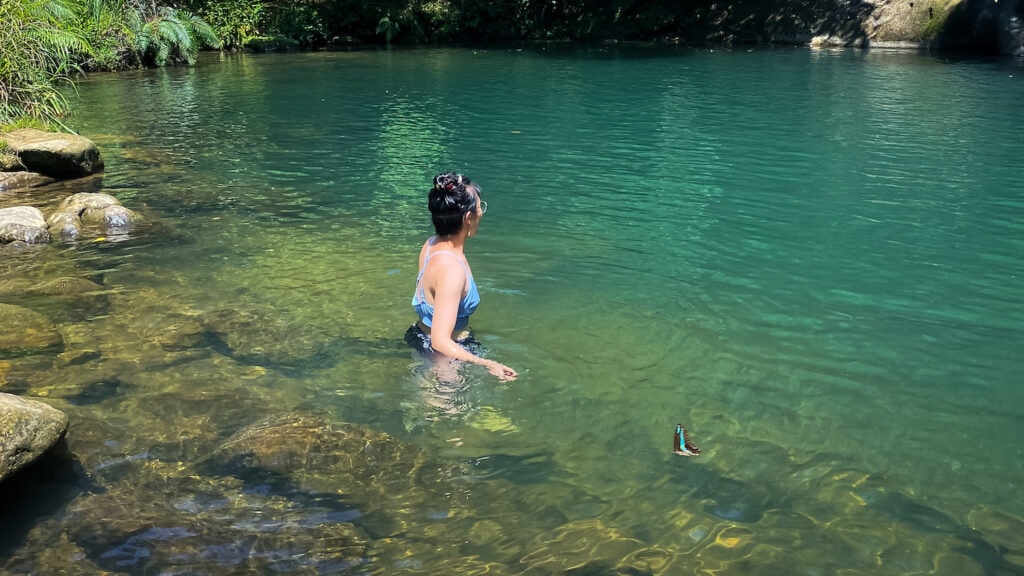 East Asian human wearing a bathing suit swimming at Huiyao Waterfall near Taipei